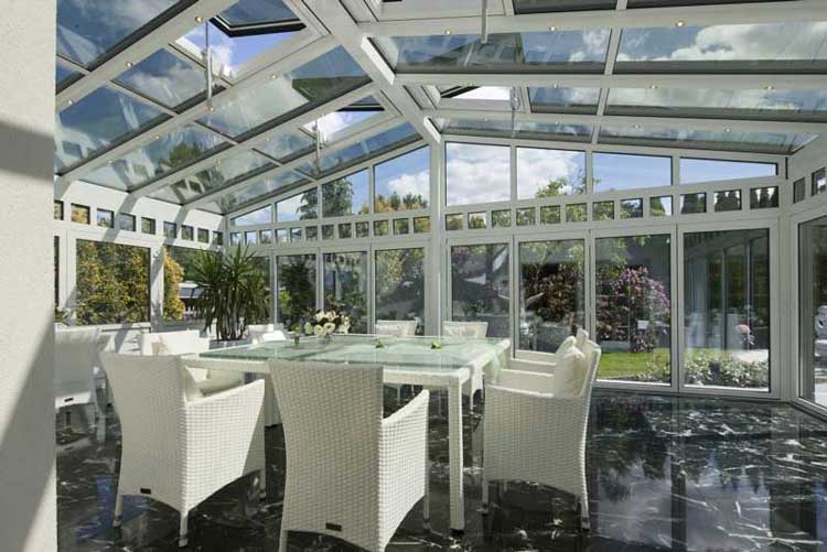 interior-of-a-conservatory-with-white-rattan-furniture-marble-flooring-and-sunshine-outside
